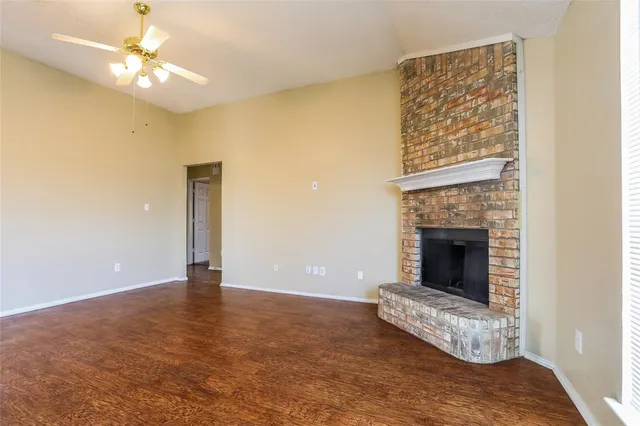 a view of an empty room with a fireplace
