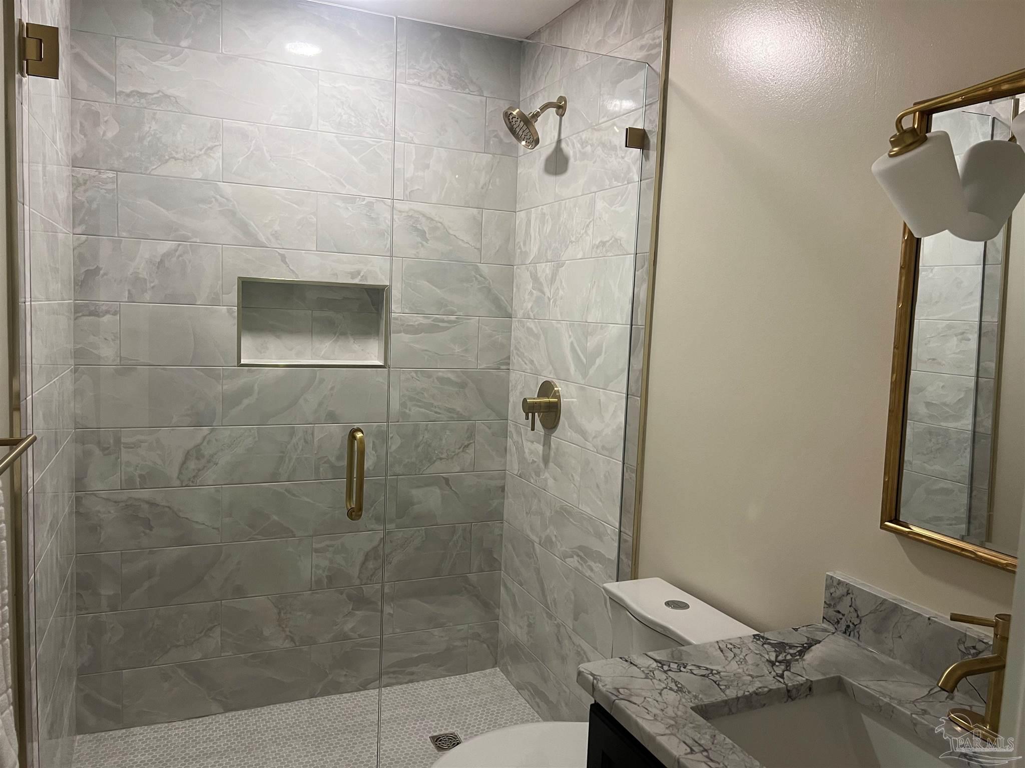 3111 Holley Point Road Navarre, FL 32566 - Photo 18 of 23 a bathroom with a granite countertop shower a toilet and a sink