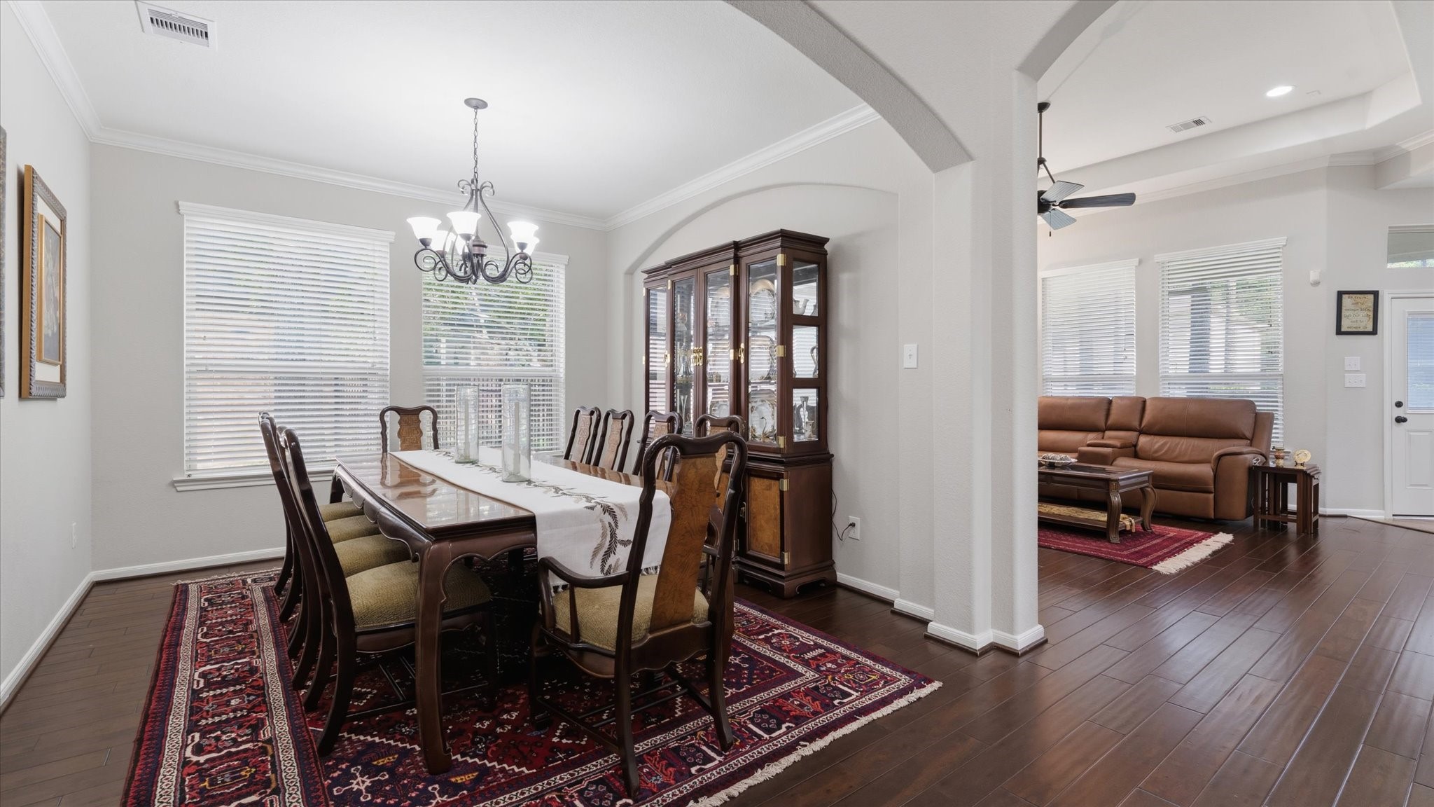 14 Painted Post Place Spring, TX 77389 - Photo 10 of 43 a view of a dining room with furniture a chandelier and wooden floor