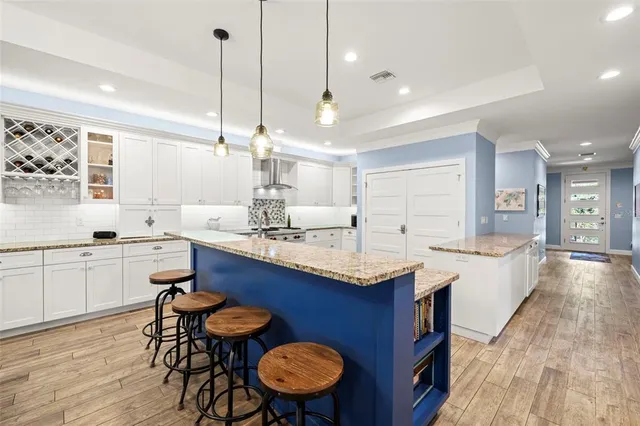 a kitchen with granite countertop a sink appliances and cabinets