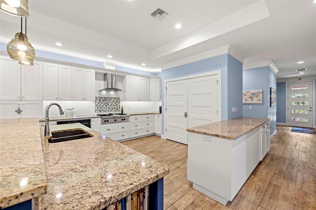2623 57th Street South Gulfport, FL 33707 - Photo 15 of 50 a kitchen with granite countertop a sink stove and cabinets
