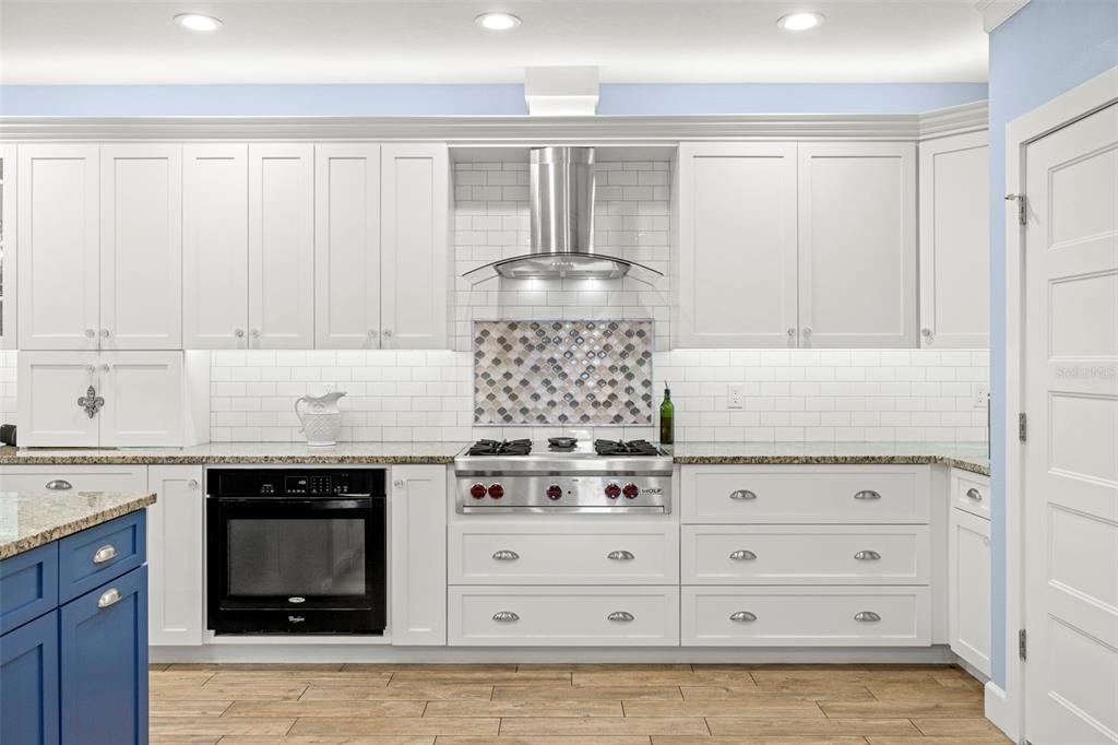 2623 57th Street South Gulfport, FL 33707 - Photo 19 of 50 a kitchen with granite countertop white cabinets and white appliances