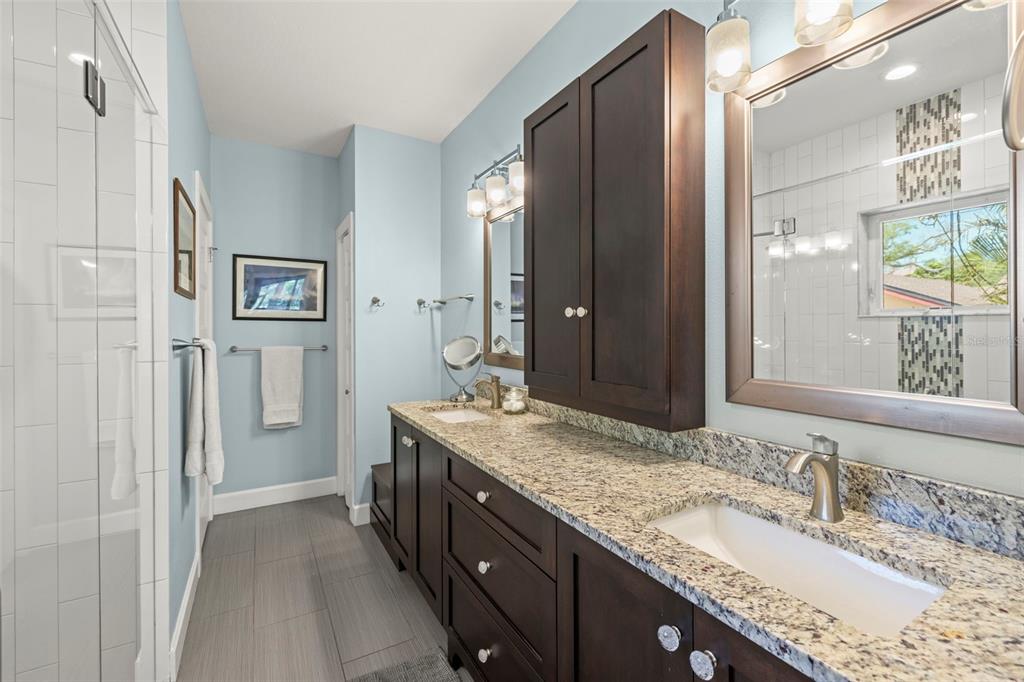 2623 57th Street South Gulfport, FL 33707 - Photo 26 of 50 a bathroom with a granite countertop double vanity sink and a mirror