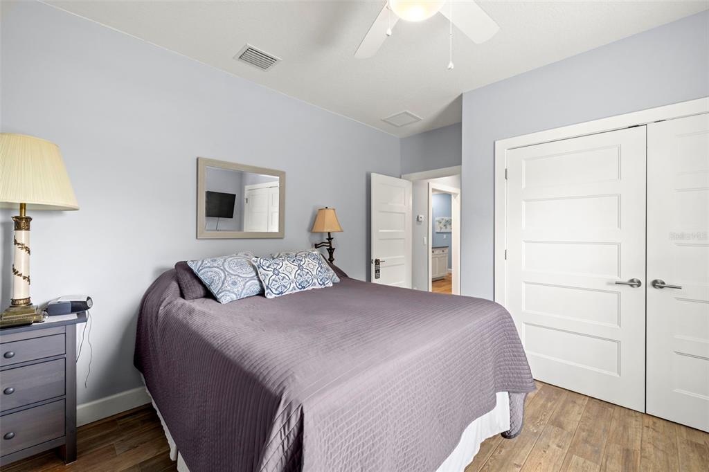 2623 57th Street South Gulfport, FL 33707 - Photo 28 of 50 a bedroom with a bed and a lamp on dresser