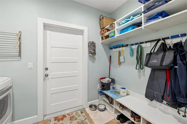 a view of walk in closet with clothes and shoes