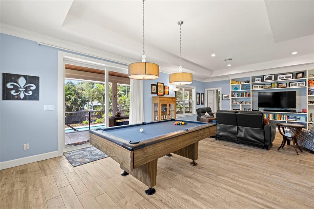 2623 57th Street South Gulfport, FL 33707 - Photo 9 of 50 a living room with furniture a flat screen tv and floor to ceiling window