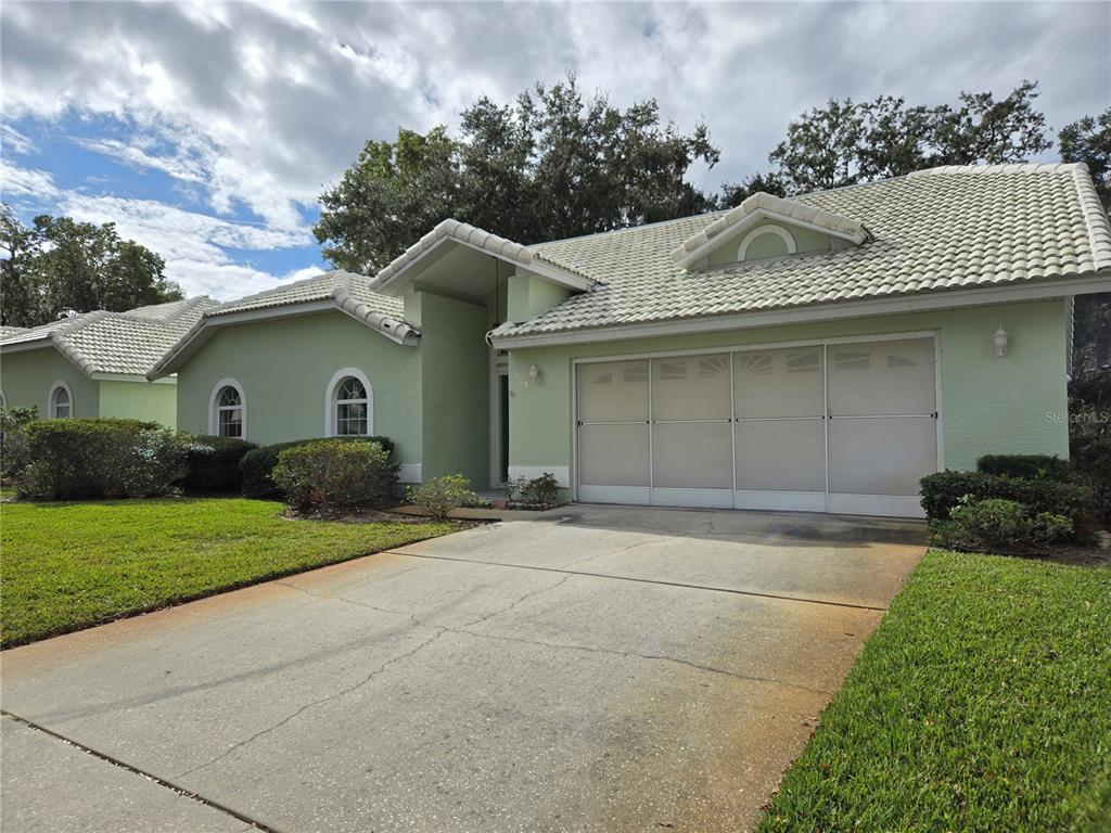 719 Balmoral Court Inverness, FL 34453 - Photo 1 of 29 a front view of a house with a yard and garage