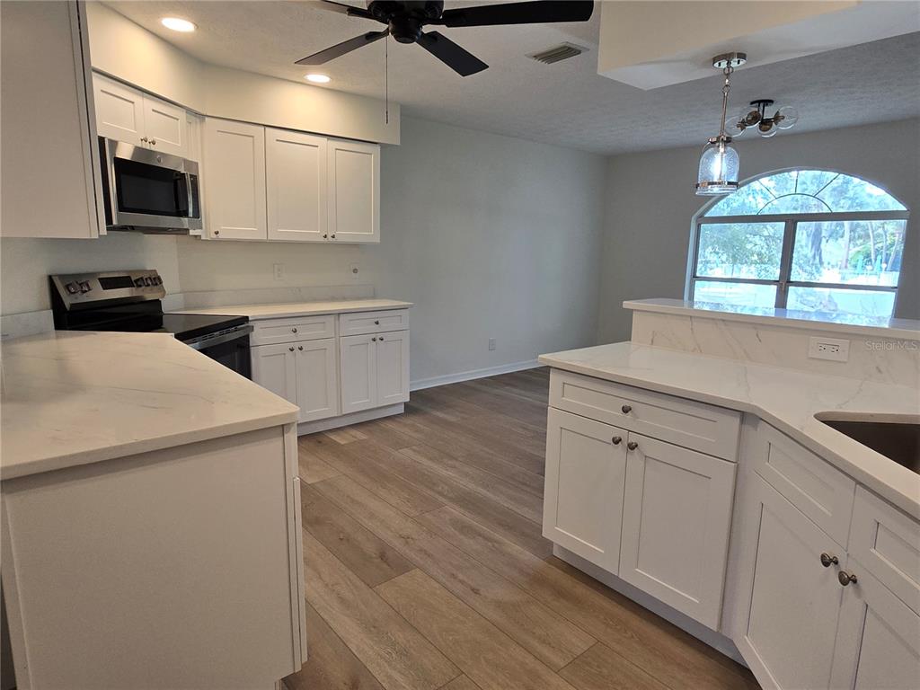 719 Balmoral Court Inverness, FL 34453 - Photo 12 of 29 a kitchen with a sink appliances and cabinets