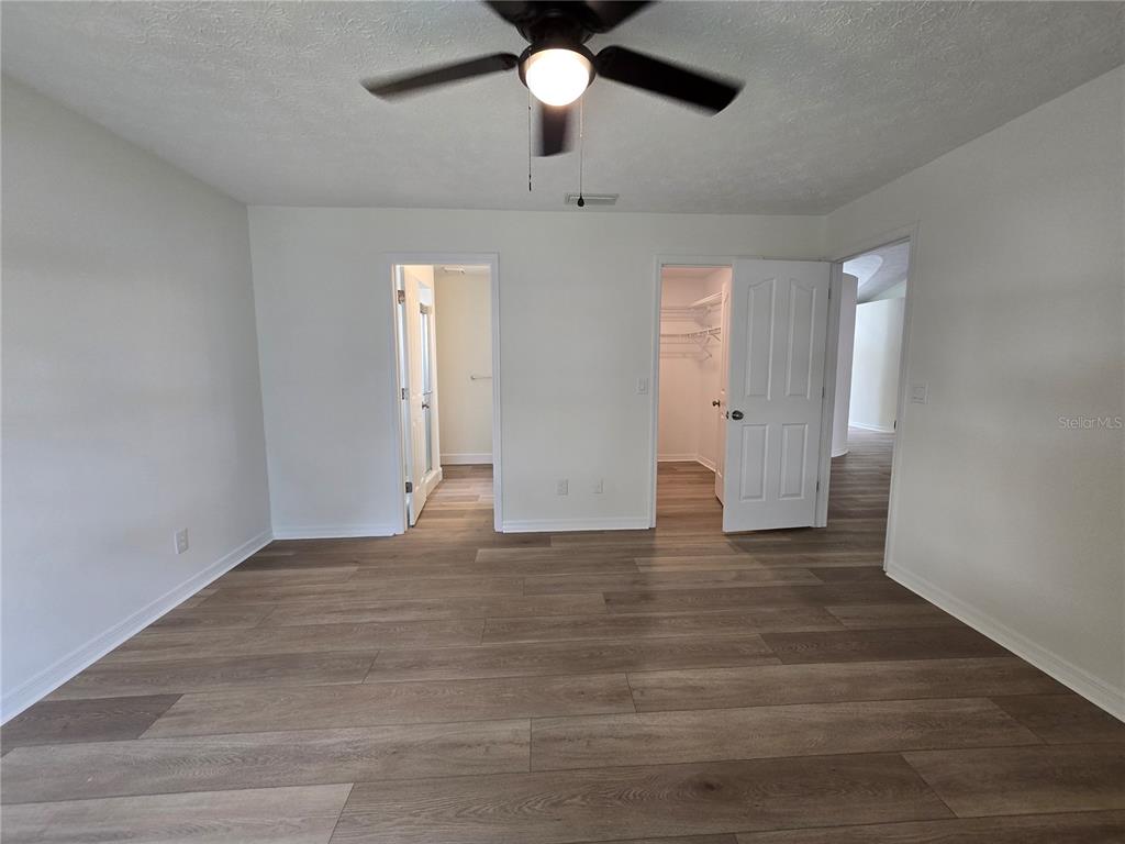 719 Balmoral Court Inverness, FL 34453 - Photo 17 of 29 a view of an empty room with window and wooden floor