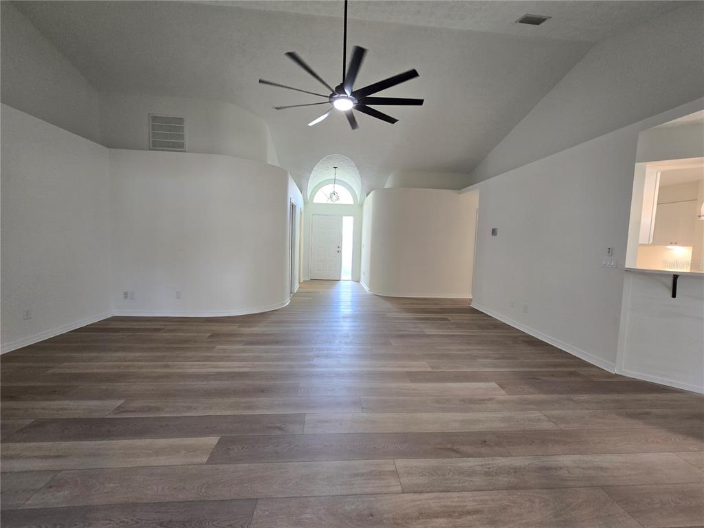 719 Balmoral Court Inverness, FL 34453 - Photo 20 of 29 a view of an empty room with wooden floor and a window