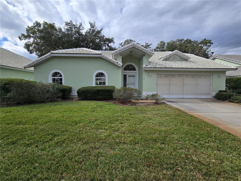 719 Balmoral Court Inverness, FL 34453 - Photo 2 of 29 a front view of a house with garden