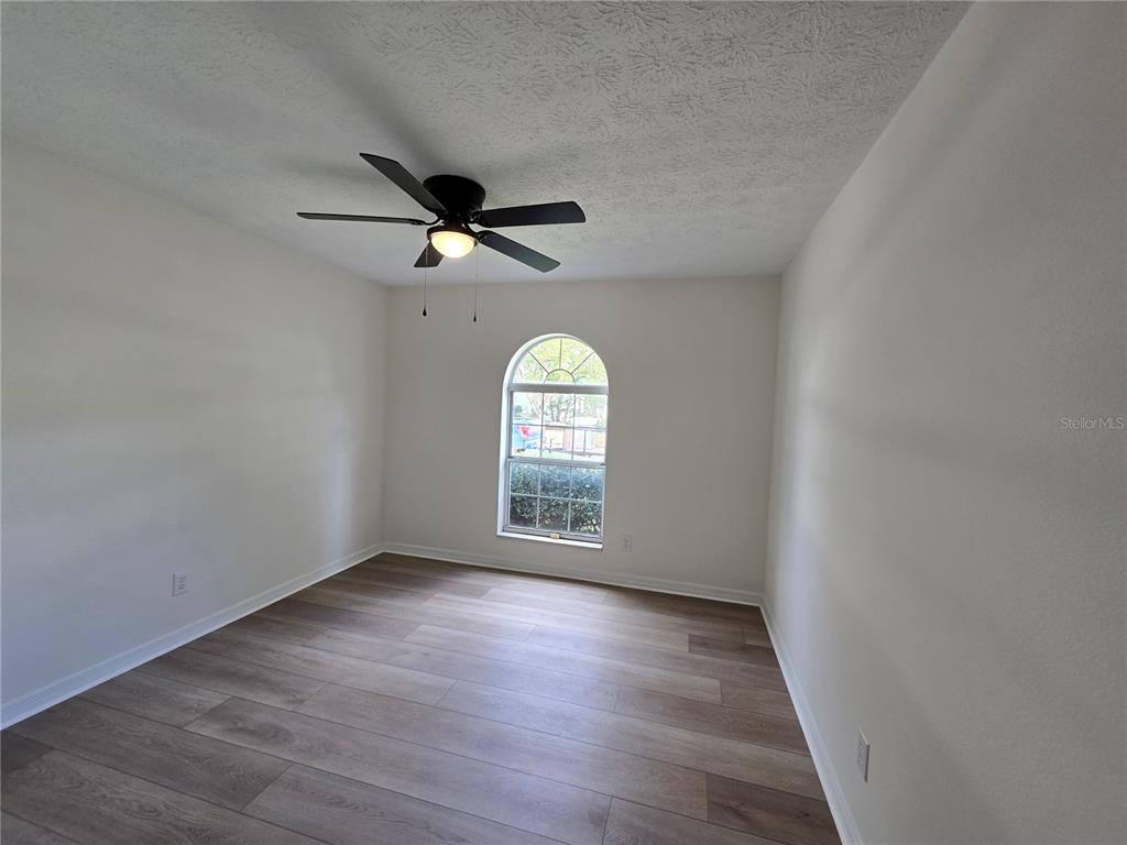 719 Balmoral Court Inverness, FL 34453 - Photo 21 of 29 a view of an empty room with window and wooden floor