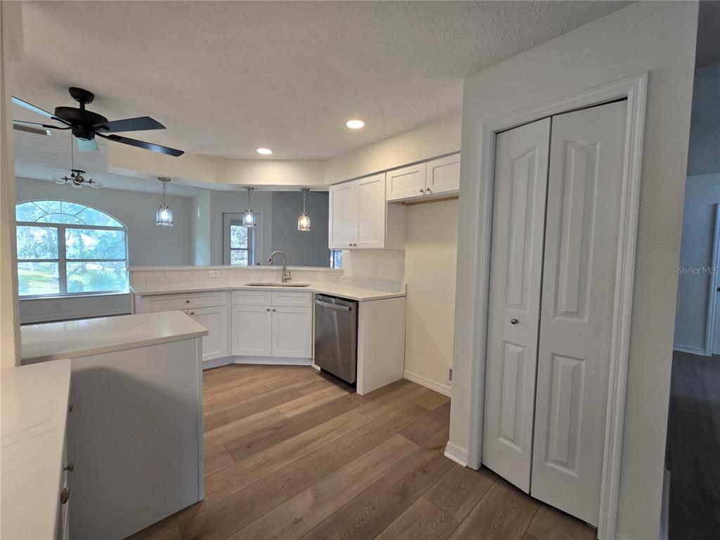 719 Balmoral Court Inverness, FL 34453 - Photo 24 of 29 a large kitchen with a window and stainless steel appliances