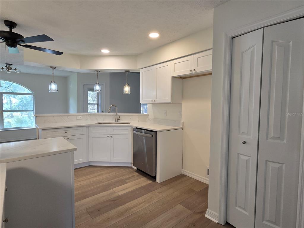 719 Balmoral Court Inverness, FL 34453 - Photo 25 of 29 a kitchen with white cabinets and white appliances