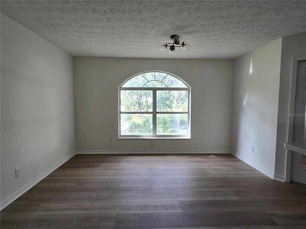 719 Balmoral Court Inverness, FL 34453 - Photo 26 of 29 an empty room with wooden floor and windows