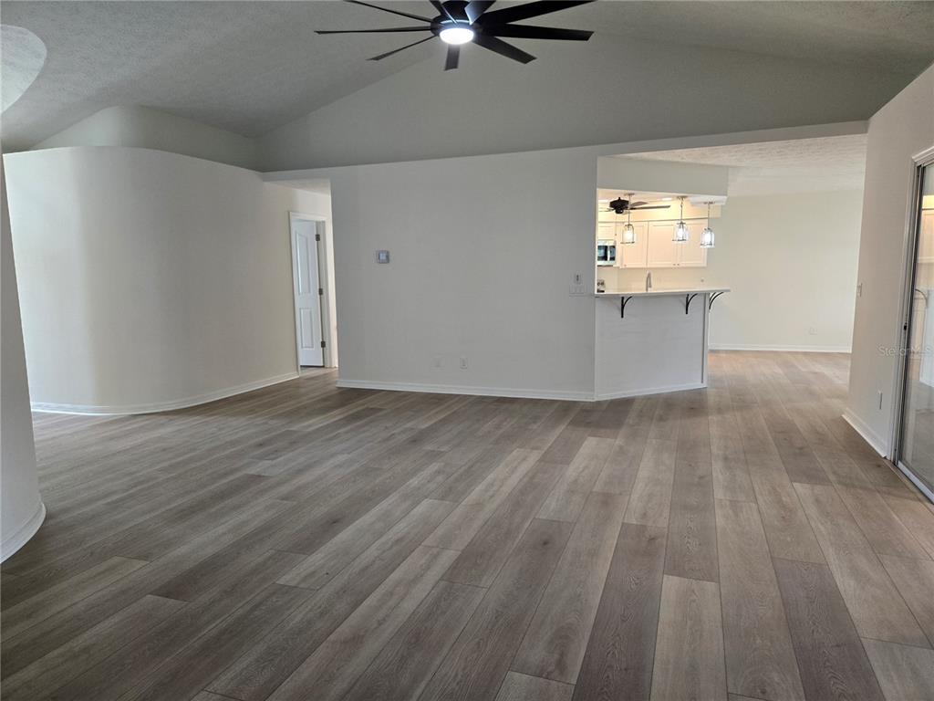 719 Balmoral Court Inverness, FL 34453 - Photo 4 of 29 wooden floor in an empty room with a window