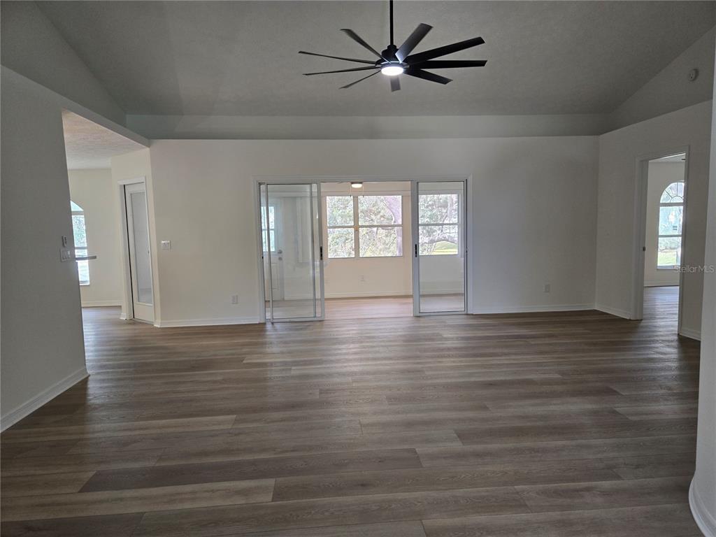 719 Balmoral Court Inverness, FL 34453 - Photo 5 of 29 a view of empty room with wooden floor and fan