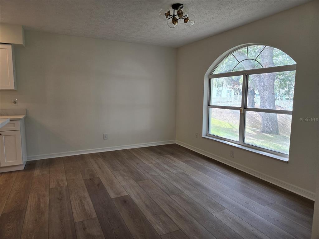 719 Balmoral Court Inverness, FL 34453 - Photo 7 of 29 wooden floor in an empty room with a window