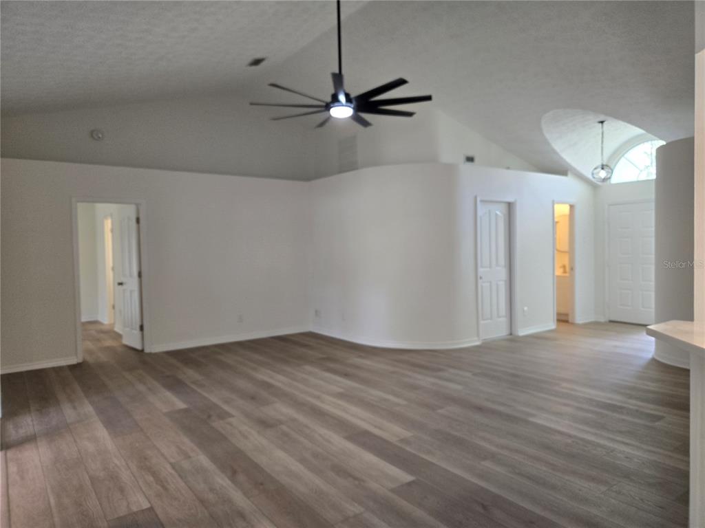 719 Balmoral Court Inverness, FL 34453 - Photo 8 of 29 a view of an empty room with a window and wooden floor