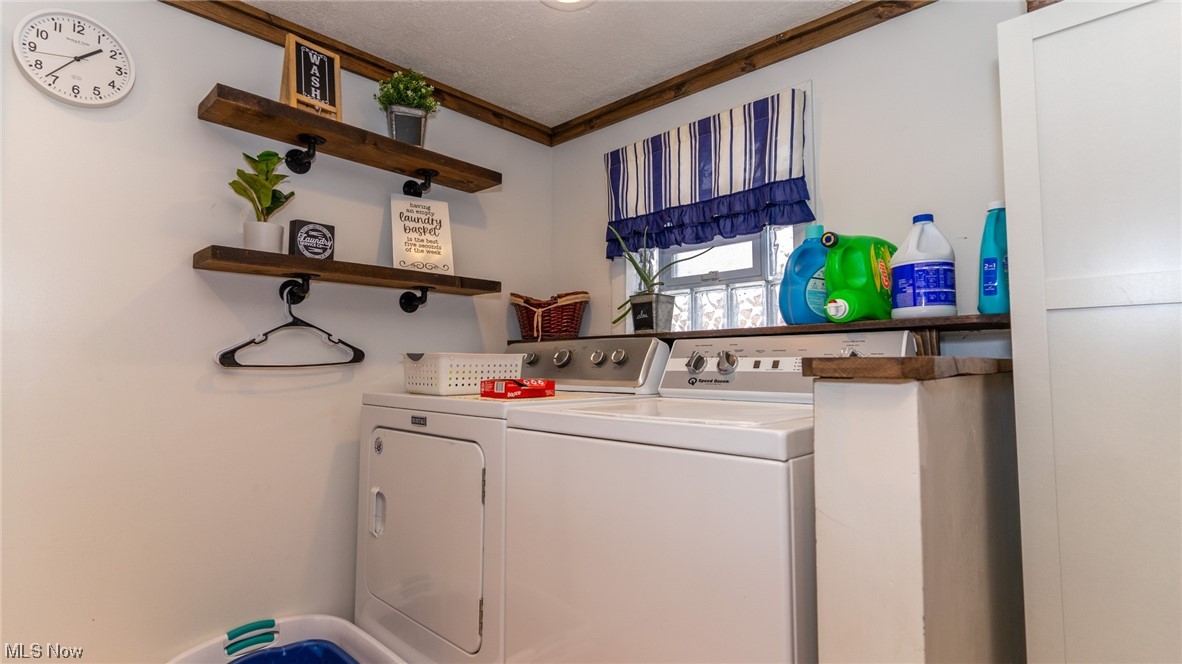 13962 Nickel Plate Road Logan, OH 43138 - Photo 24 of 46 Washroom with ornamental molding, a textured ceiling, and washing machine and clothes dryer