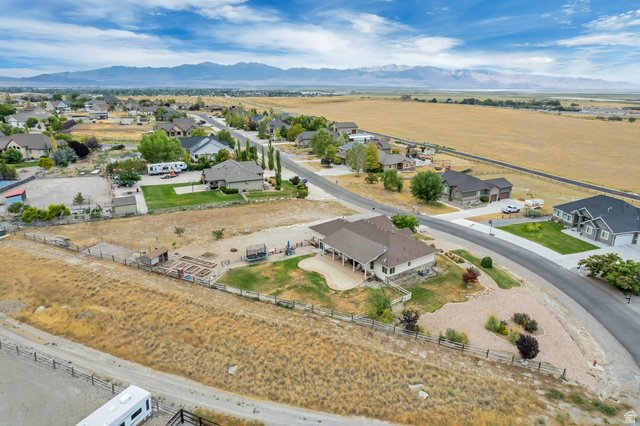 7296 Ridge Road Lake Point, UT 84074 - Photo 51 of 54 Expansive property featuring a paved driveway, a large rear patio, mature landscaping, and mountain scenery