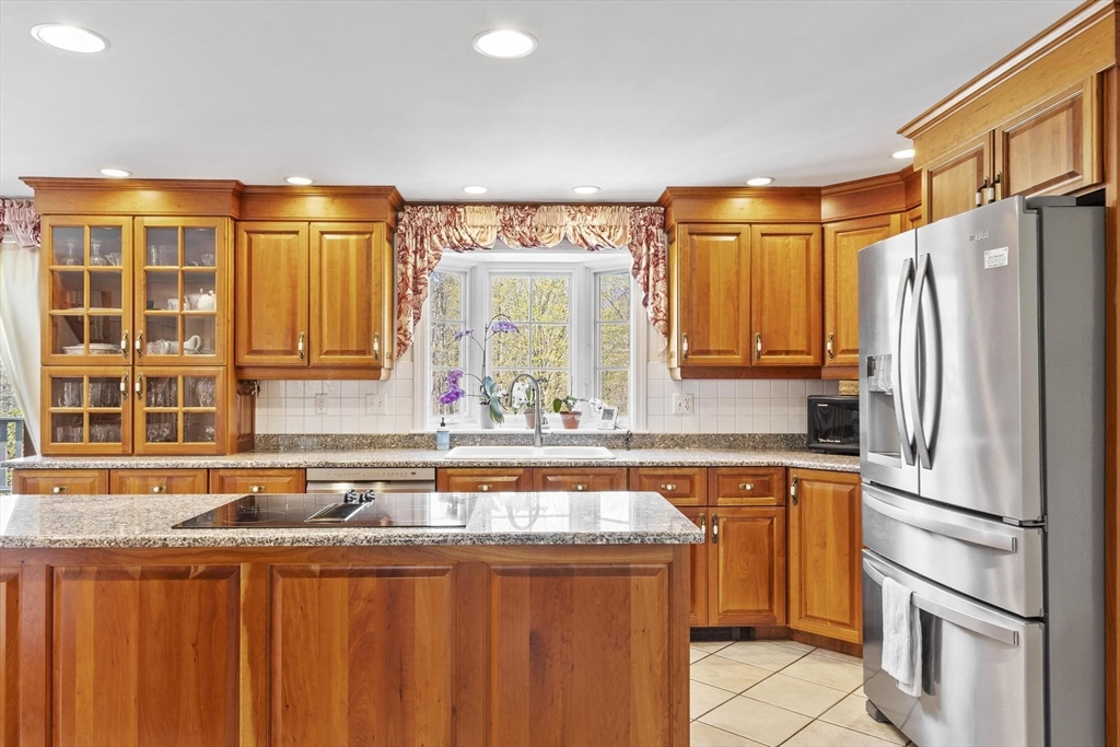 103 Brooks Station Road Princeton, MA 01541 - Photo 14 of 42 a kitchen with stainless steel appliances granite countertop a refrigerator and a sink