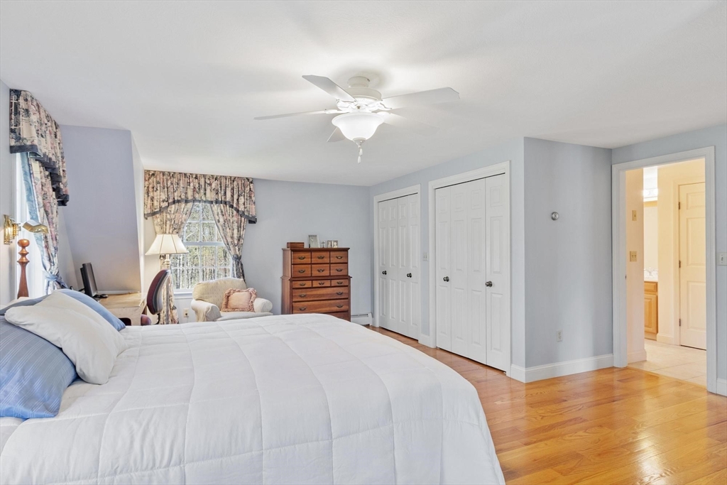 103 Brooks Station Road Princeton, MA 01541 - Photo 26 of 42 a bedroom with a bed and a chandelier