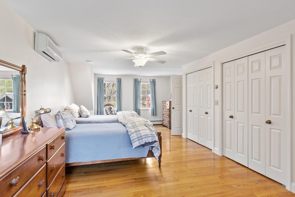 103 Brooks Station Road Princeton, MA 01541 - Photo 30 of 42 a spacious bedroom with a bed a dresser and a large window