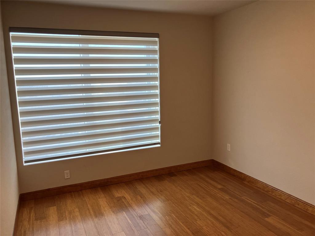 1220 West Trinity Mills Road, Unit 5009 Carrollton, TX 75006 - Photo 14 of 25 a view of a room with wooden floor and a window