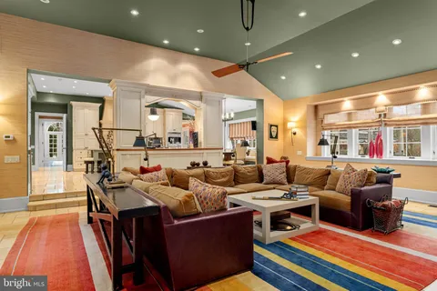 a view of a kitchen with furniture and natural light