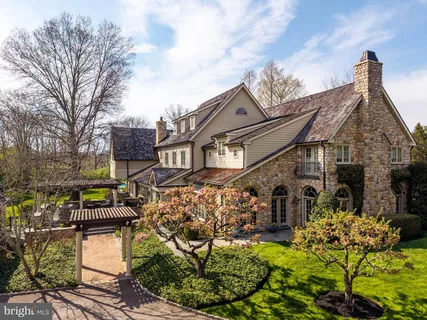 a view of a house with sitting area and garden