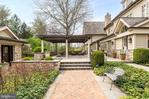 an aerial view of a house with a yard swimming pool and outdoor seating