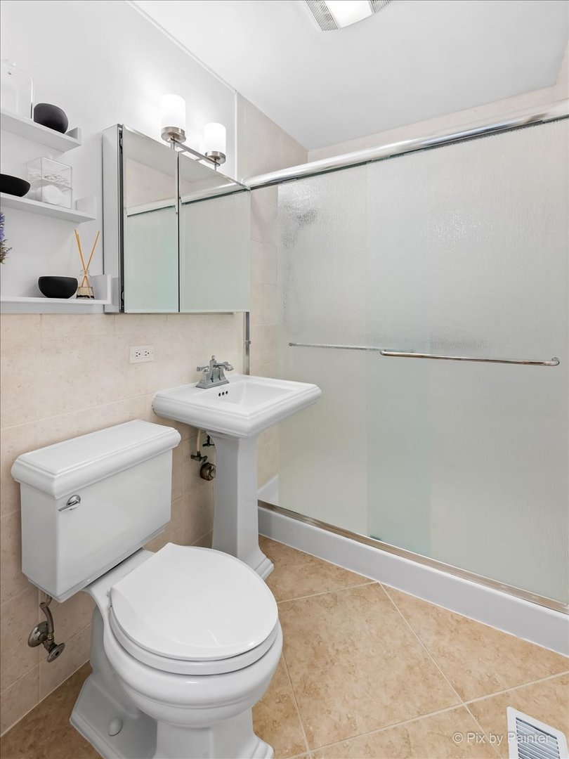 34 Johnathan Road Lake Zurich, IL 60047 - Photo 16 of 27 a bathroom with a sink a toilet and shower