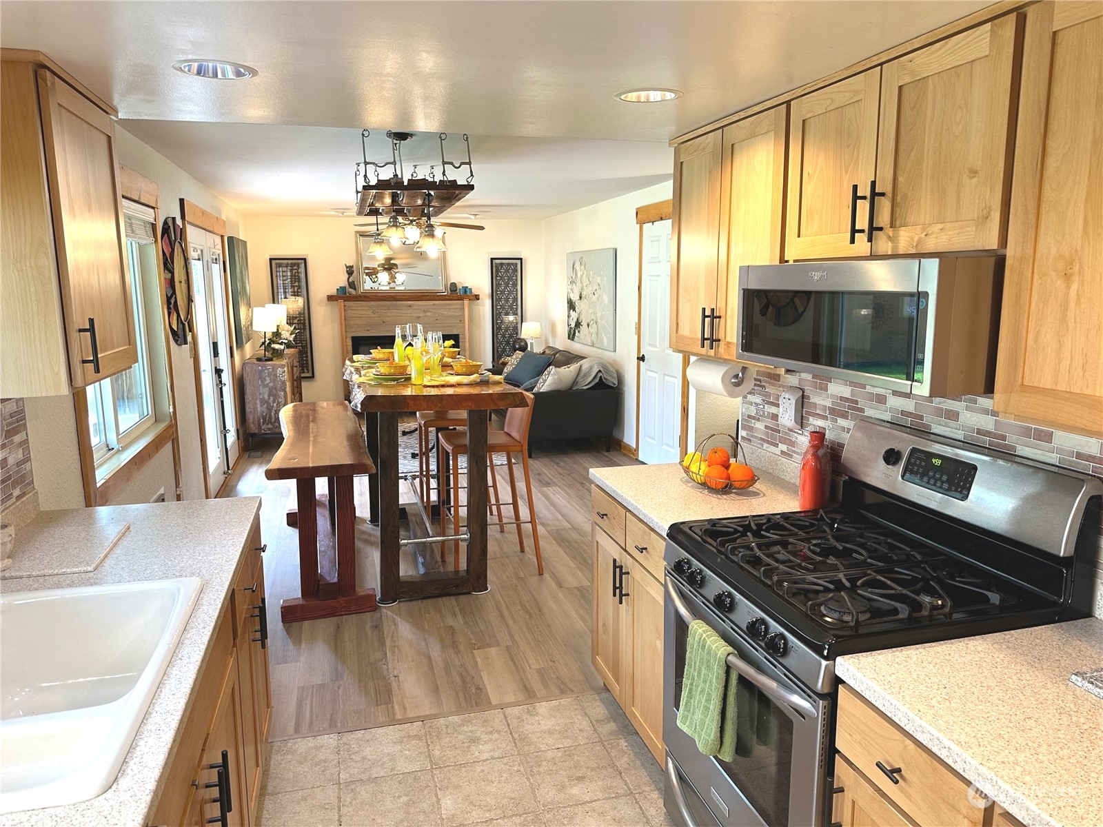 2814 Stafford Way Bothell, WA 98012 - Photo 15 of 38 a kitchen with stainless steel appliances granite countertop a stove refrigerator and a view of living room