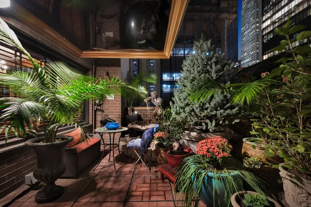 a view of a living room and a lots of books