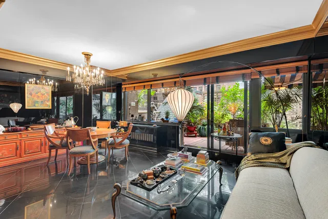 a living room filled with furniture and a large window