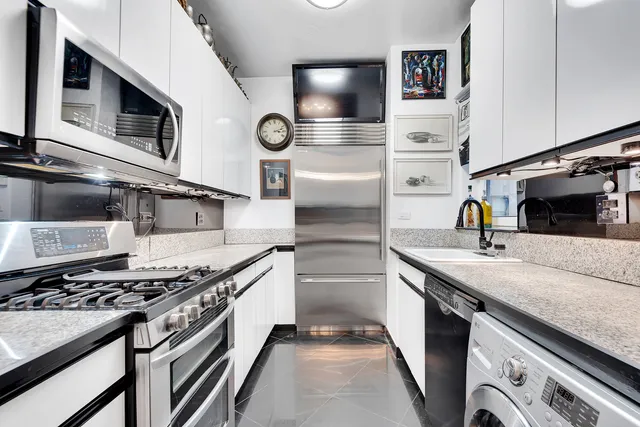 a dining room with furniture a rug and a large window
