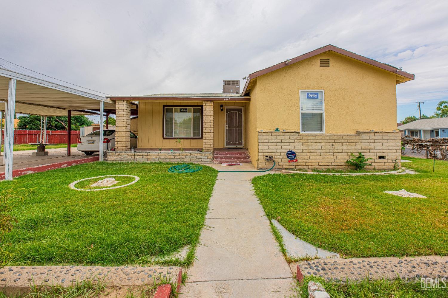 a view of a house with a yard and sitting area
