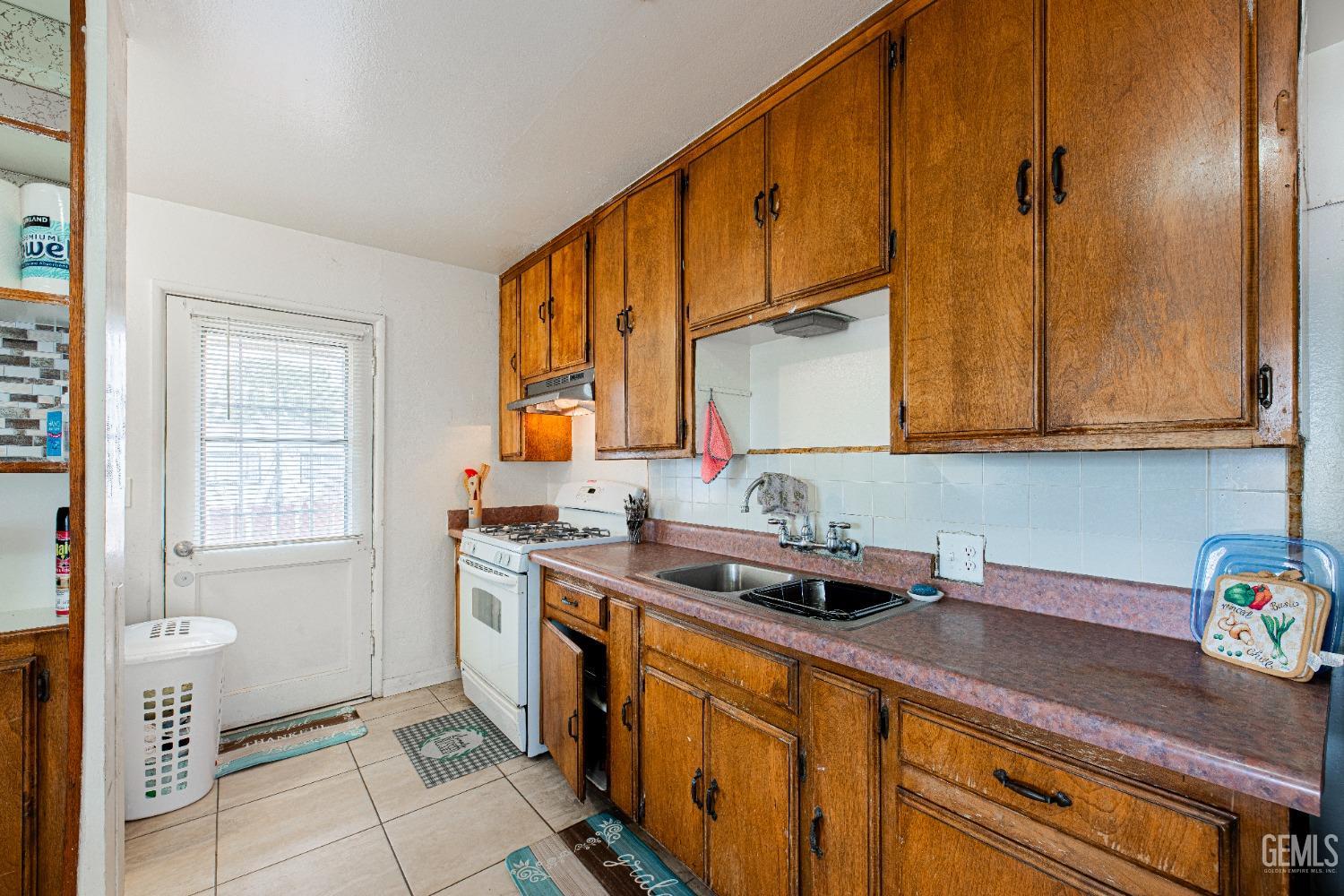 Undisclosed Address Bakersfield, CA 93307 - Photo 12 of 27 a kitchen with a sink cabinets and window