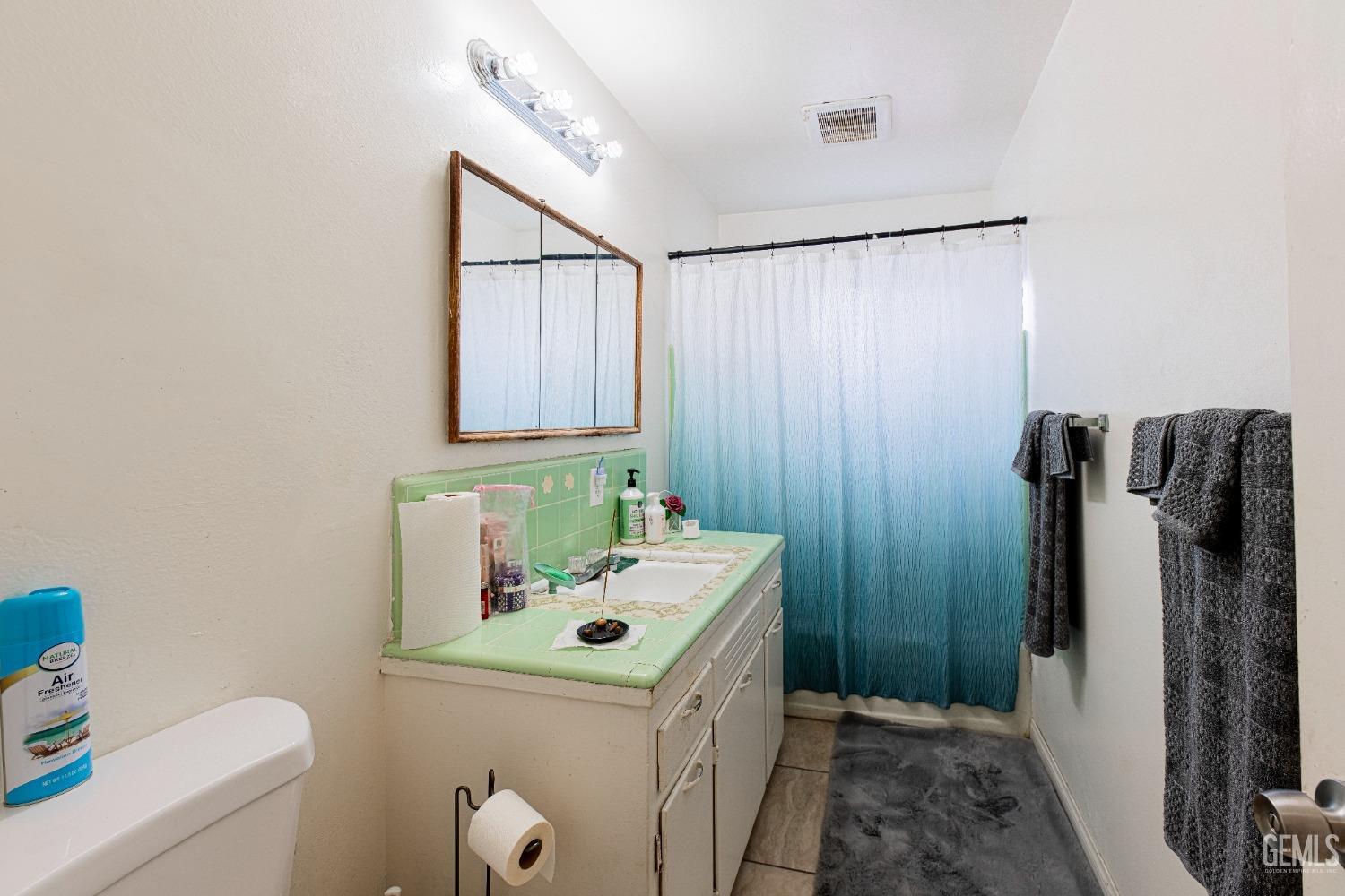 Undisclosed Address Bakersfield, CA 93307 - Photo 16 of 27 a bathroom with a sink toilet and shower