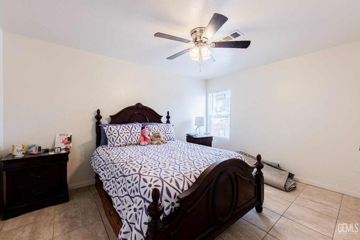 Undisclosed Address Bakersfield, CA 93307 - Photo 17 of 27 a bedroom with a bed and a chandelier