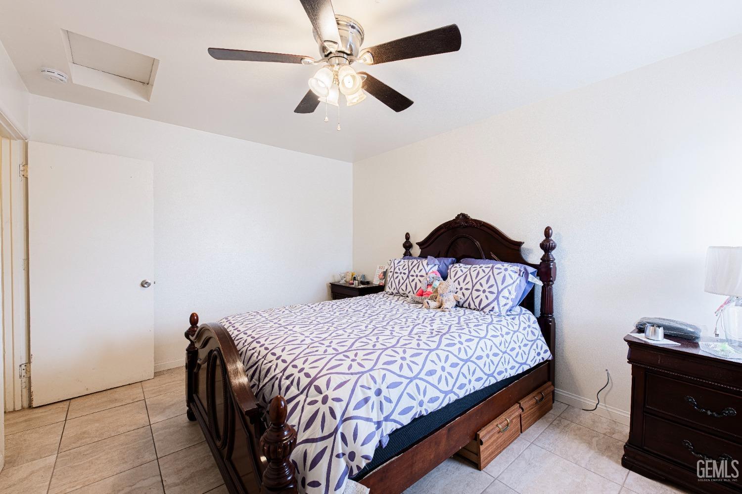 Undisclosed Address Bakersfield, CA 93307 - Photo 19 of 27 a bedroom with a bed and a ceiling fan