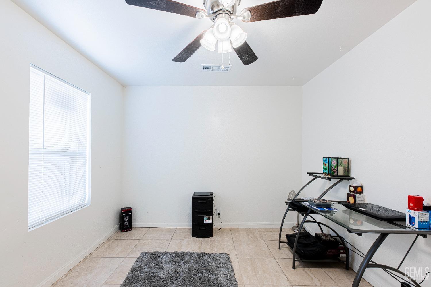 Undisclosed Address Bakersfield, CA 93307 - Photo 21 of 27 a view of a workspace with furniture and a window