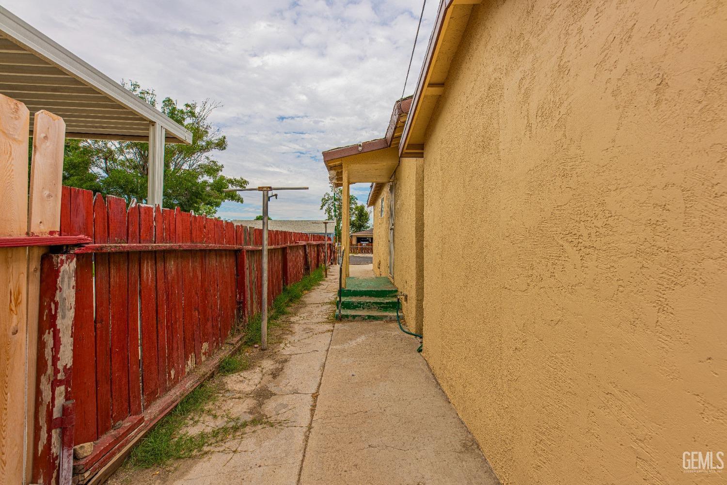 Undisclosed Address Bakersfield, CA 93307 - Photo 24 of 27 a view of a pathway with a wooden fence