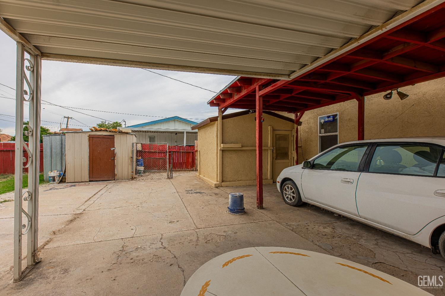 Undisclosed Address Bakersfield, CA 93307 - Photo 5 of 27 a view of a patio with table and chairs under an umbrella