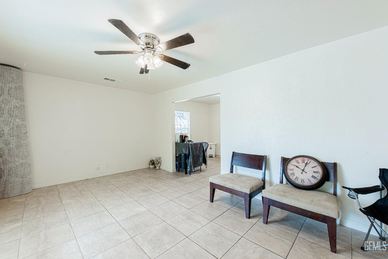 Undisclosed Address Bakersfield, CA 93307 - Photo 7 of 27 a living room with furniture and a clock