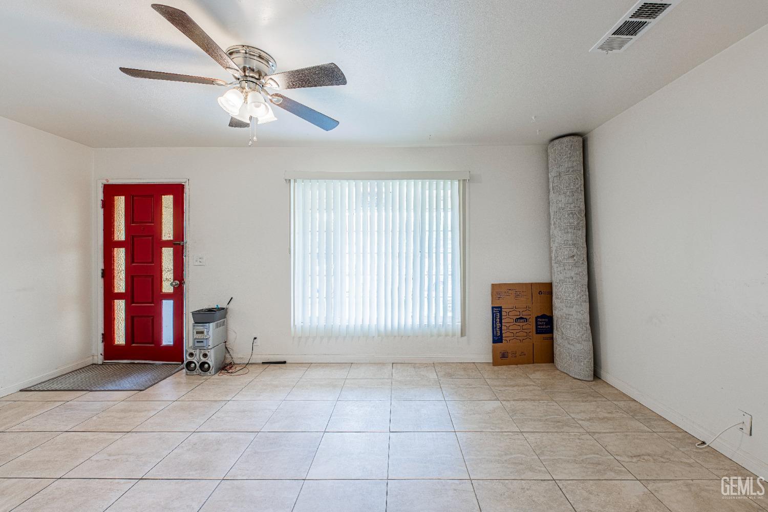 Undisclosed Address Bakersfield, CA 93307 - Photo 10 of 27 a view of an empty room with window chandelier fan