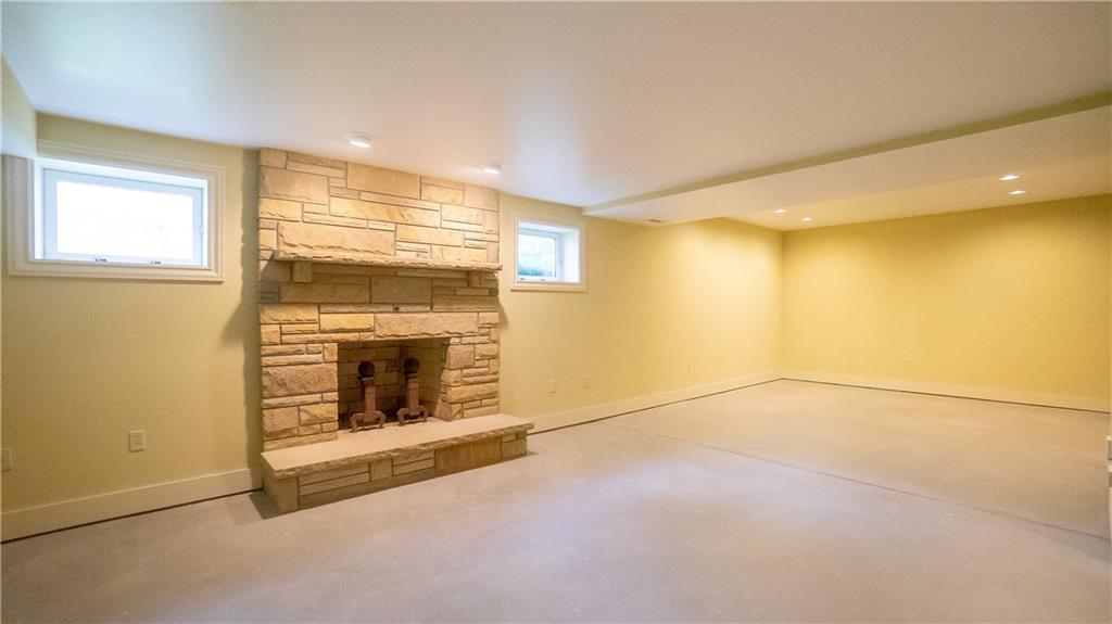 7034 Forrest Trail Road Butler, PA 16002 - Photo 22 of 25 a view of an empty room with a fireplace and a window