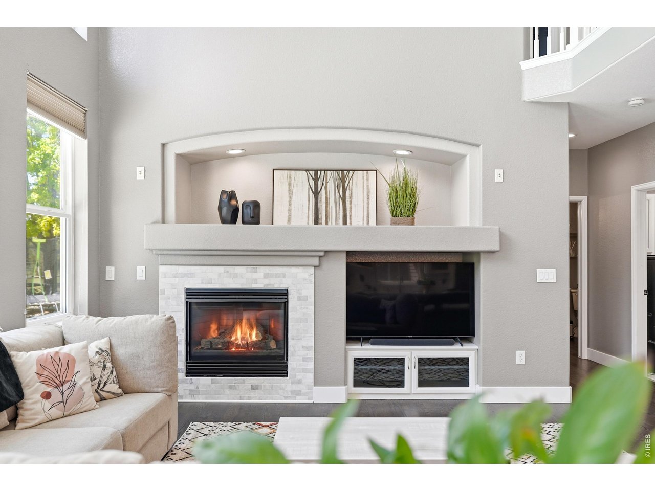 11725 Pleasant Hill Road Longmont, CO 80504 - Photo 10 of 50 The living room features a built-in entertainment center with shelving, accent lighting, and a custom tile gas fireplace.