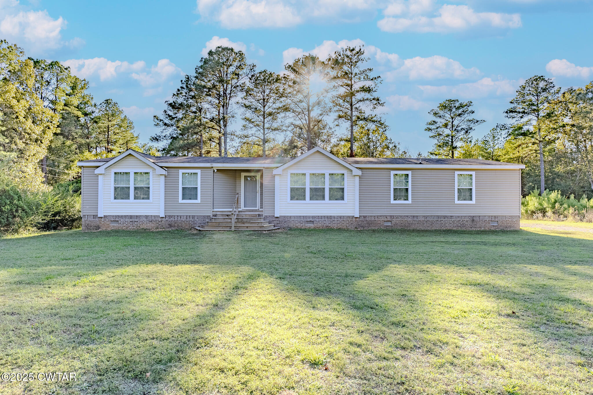 2785 Highway 138 Toone, TN 38381 - Photo 1 of 29 a view of a yard in front of a house with a garden